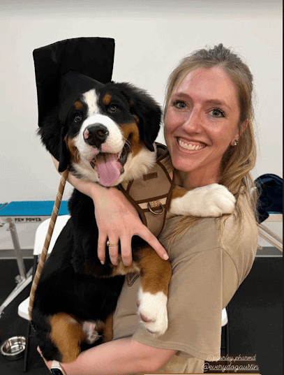 Dog Trainer Holding a Dog at Every Dog Behavior and Training